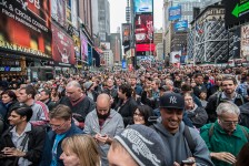 A surprised and happy crowd is text messaging, tweeting, taking pictures