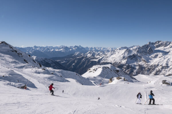 Skiing down to Italy. Italian alps in the background.