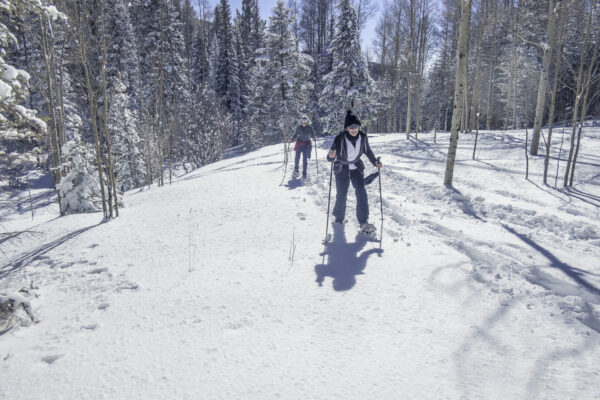 Cindy and Sabrina snowshoeing in powder snow.